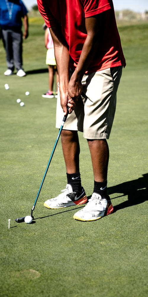Resident playing golf nearby at Glen Lakes Rental Homes in Weeki Wachee, Florida