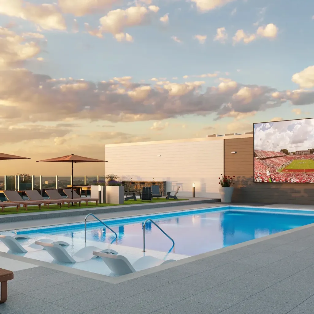 Signature at Varsity rooftop pool with sun shelf and poolside Jumbotron overlooking Raleigh.