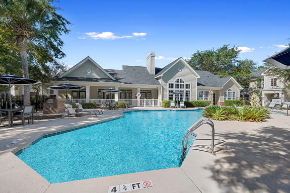 a swimming pool with a house in the background at Sweetgrass Landing, South Carolina