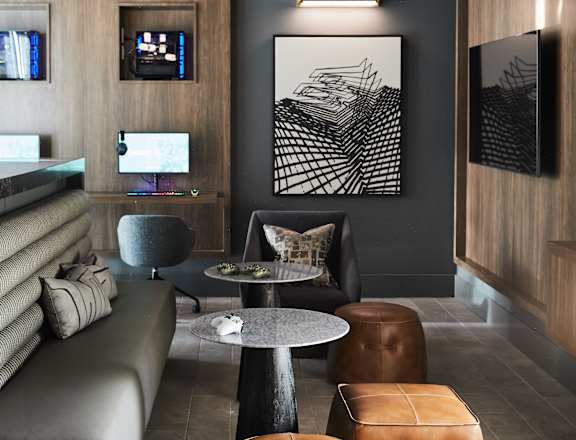 A modern living room with a grey sofa, a round table, and a TV.