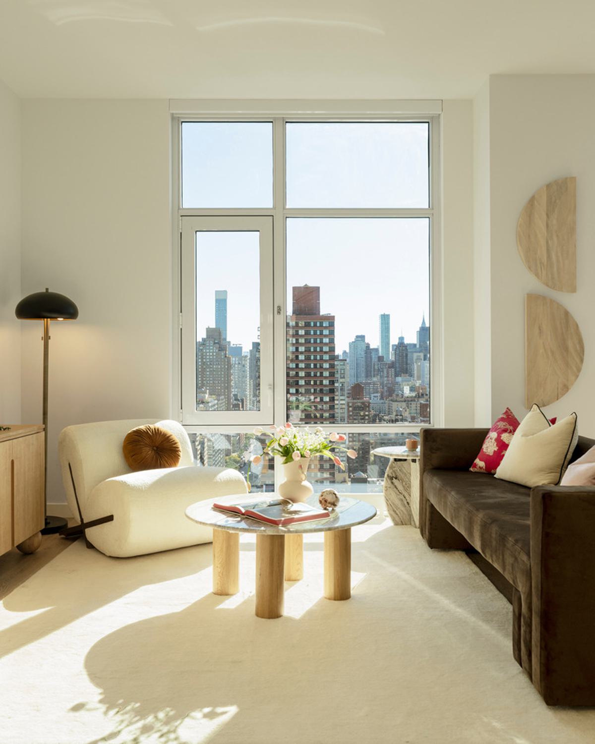 luxurious open-concept living space with floor-to-ceiling windows, a marble kitchen island, modern dining area, and a cozy lounge with panoramic city views.