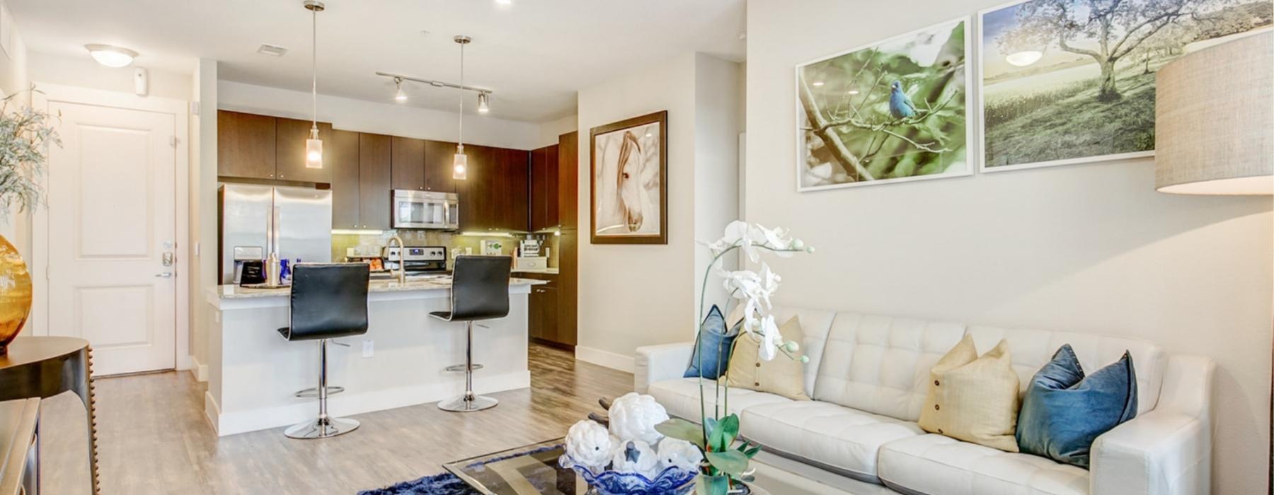 a living room with a large ceiling fan and a couch