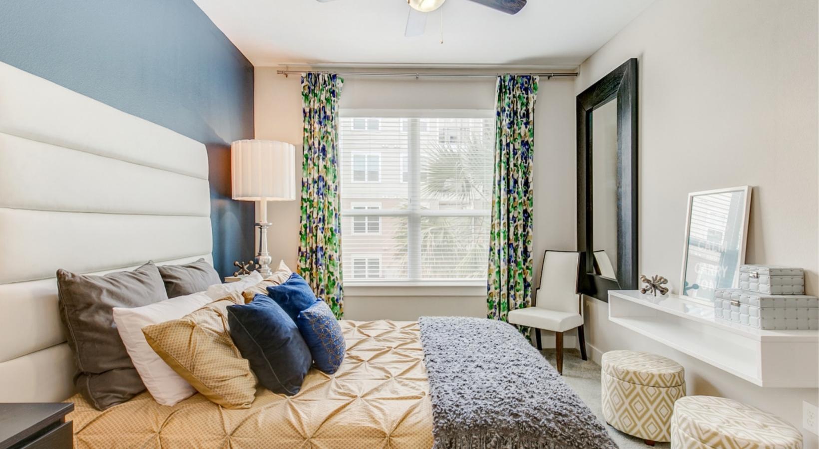 a bedroom with a bed and a fan