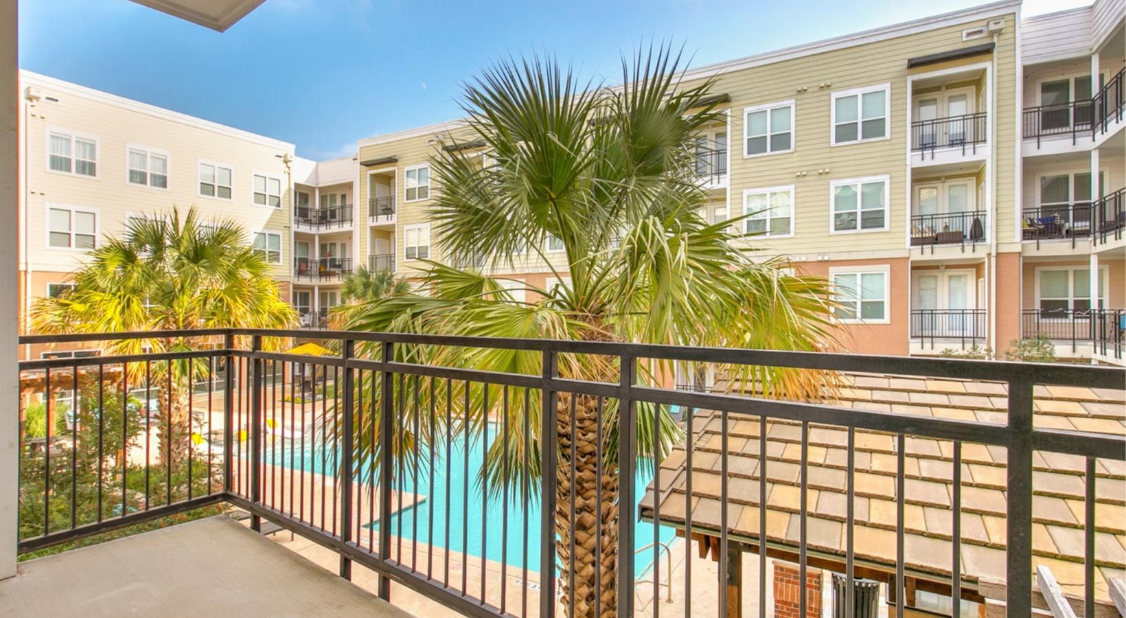 a building with a pool and trees
