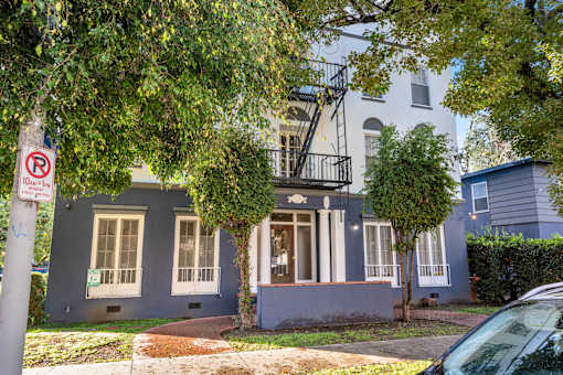 A blue house with a no parking sign in front.