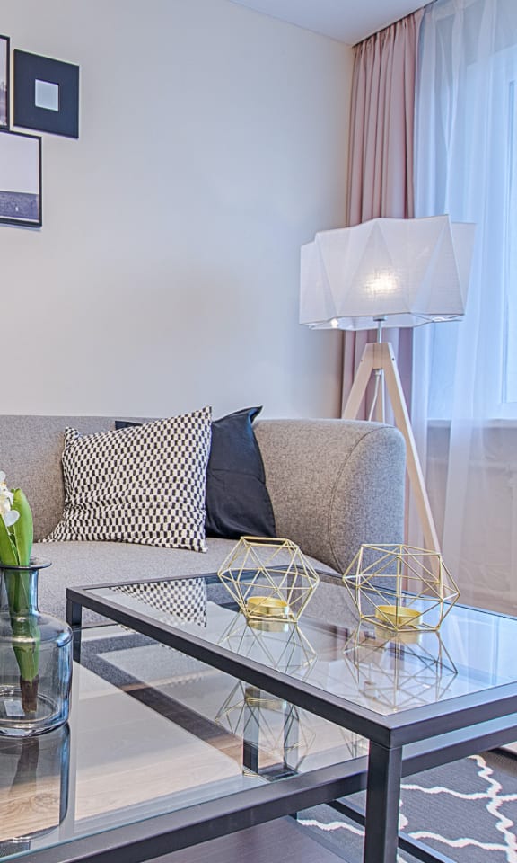 a living room with a couch and a glass table