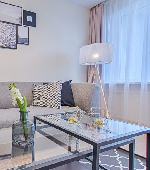 a living room with a couch and a glass table
