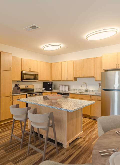 a dog and a cat are sleeping on a bed at Maison at Solivita Marketplace Apartment Homes, Florida