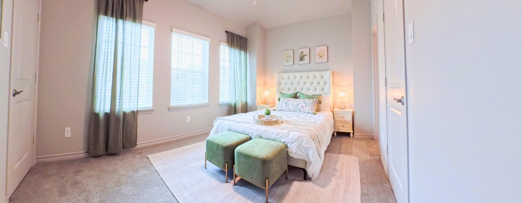a bedroom with a bed and a fan
