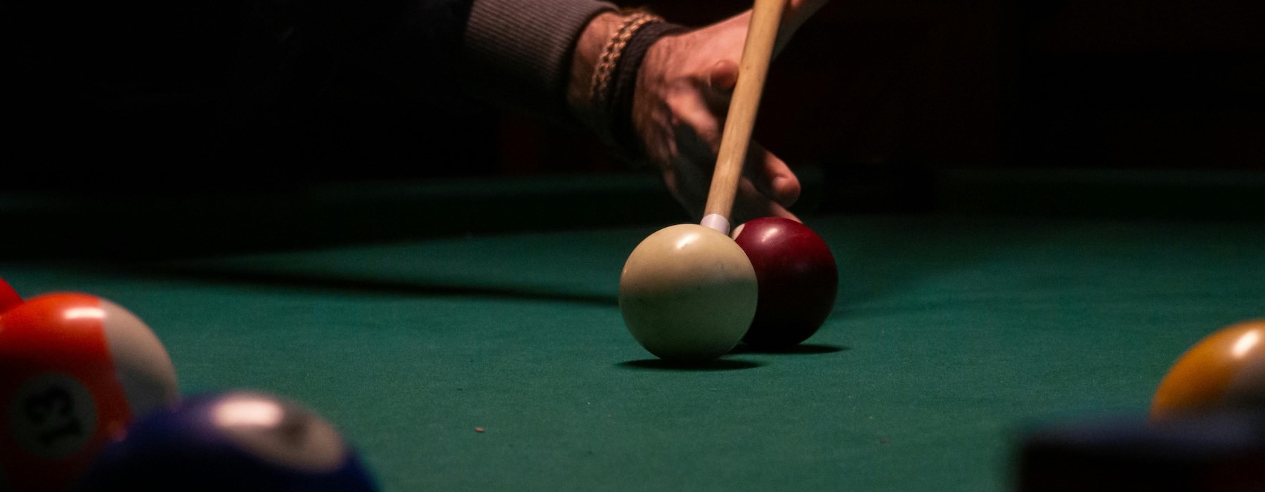 a person shooting pool