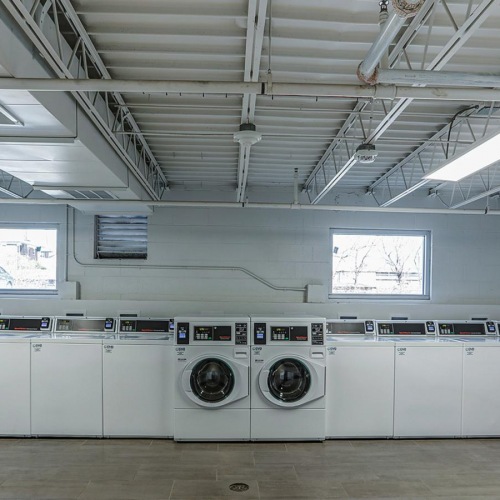 a room with laundry machines inside a Dalton Station studio apartment in Dalton, Georgia.