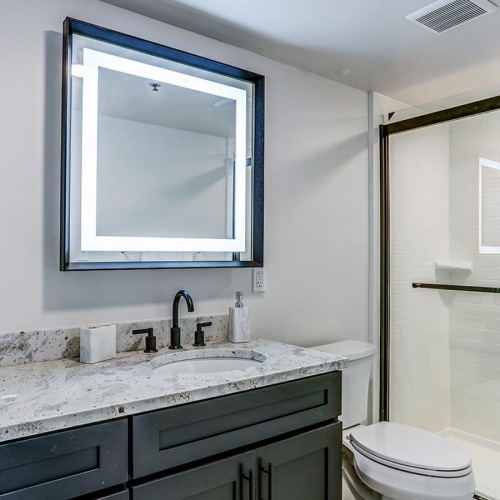 a bathroom with a marble countertop inside a Dalton Station studio apartment in Dalton, Georgia.