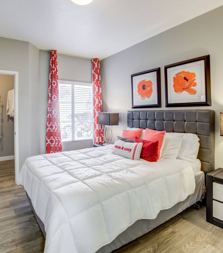 Bedroom with large windows at Calypso Apartments in Las Vegas, Nevada