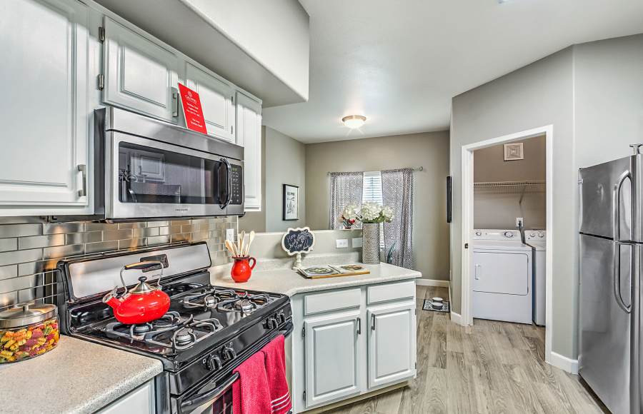 Kitchen with wood-style flooring at Calypso Apartments in Las Vegas, Nevada