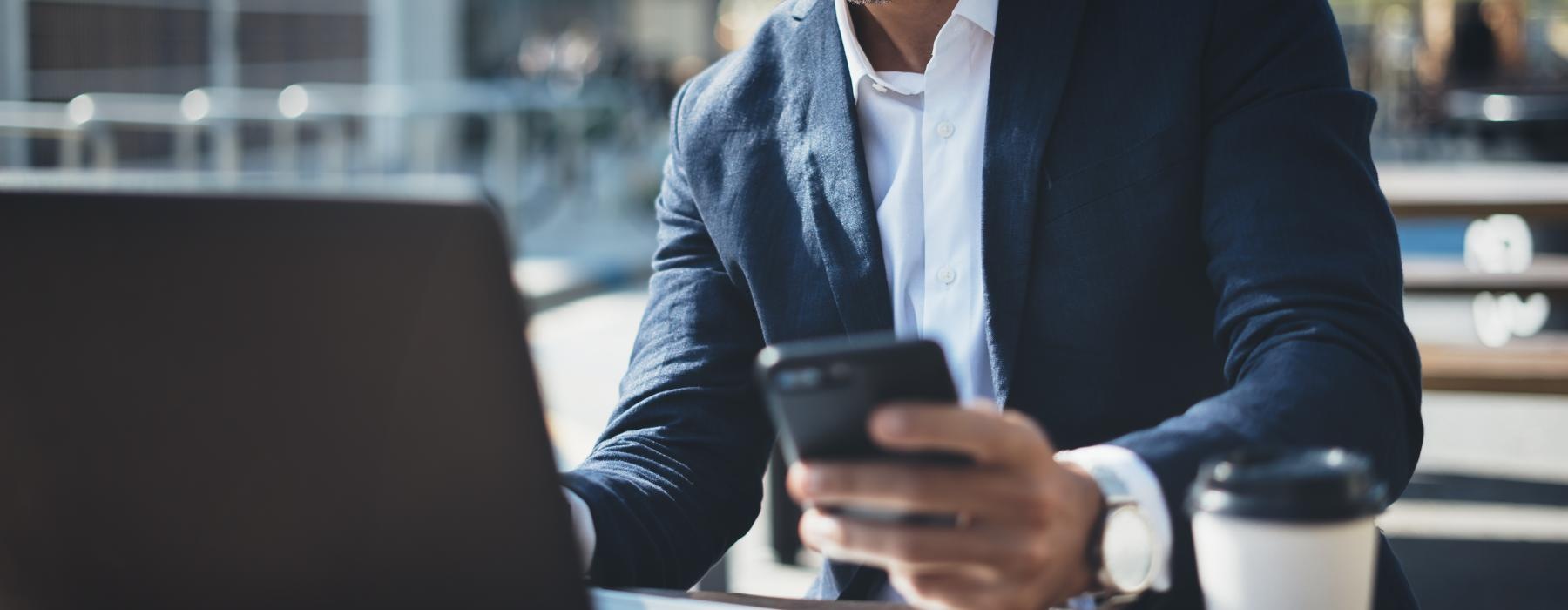 a person in a suit using a tablet