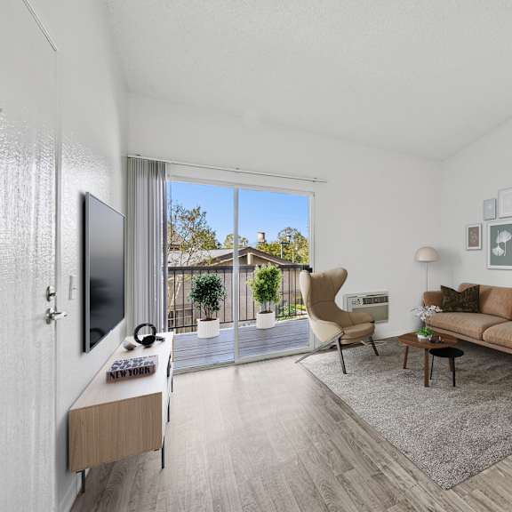 Spacious living room with large window and natural light at Sunnyside Senior Apartments in San Dimas, California