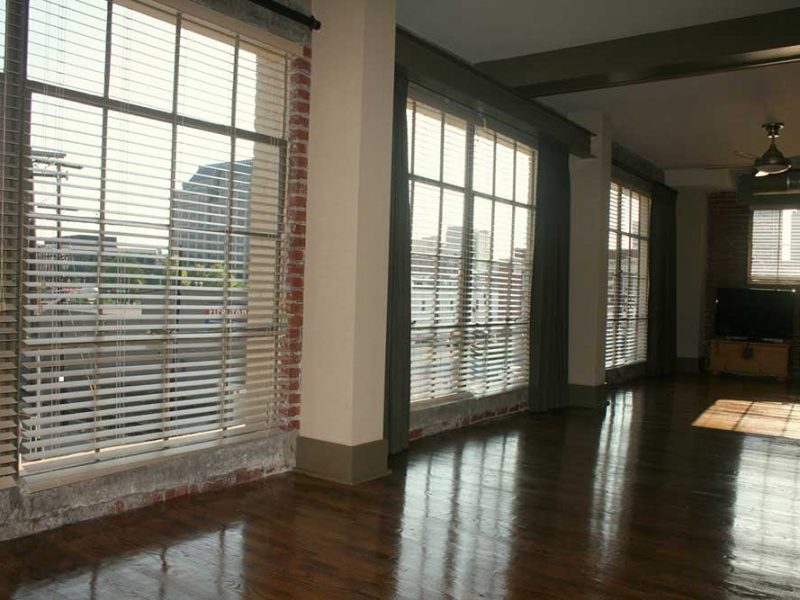Big Lick Junction living room with large windows with view of the city