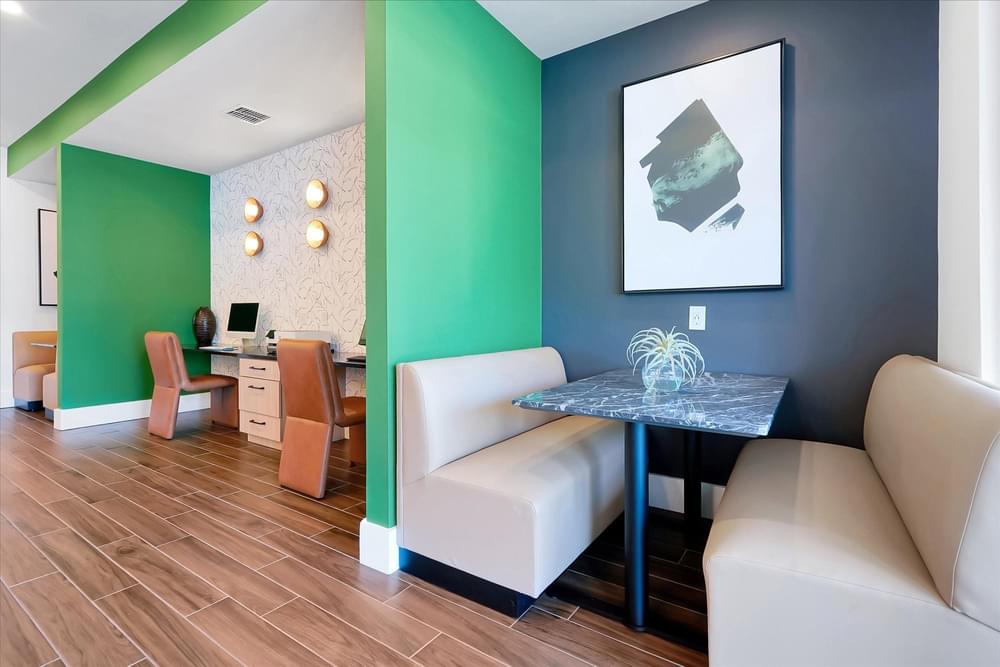 A room with a green wall and a white couch.