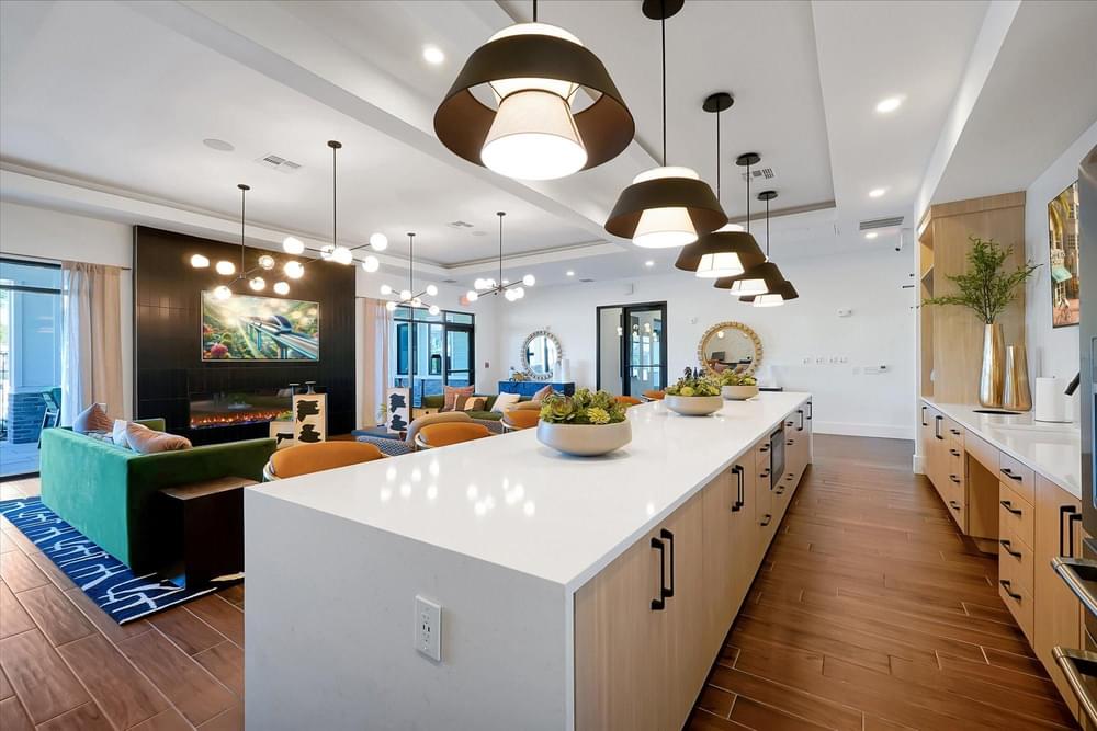 A modern kitchen with a white island and wooden cabinets.
