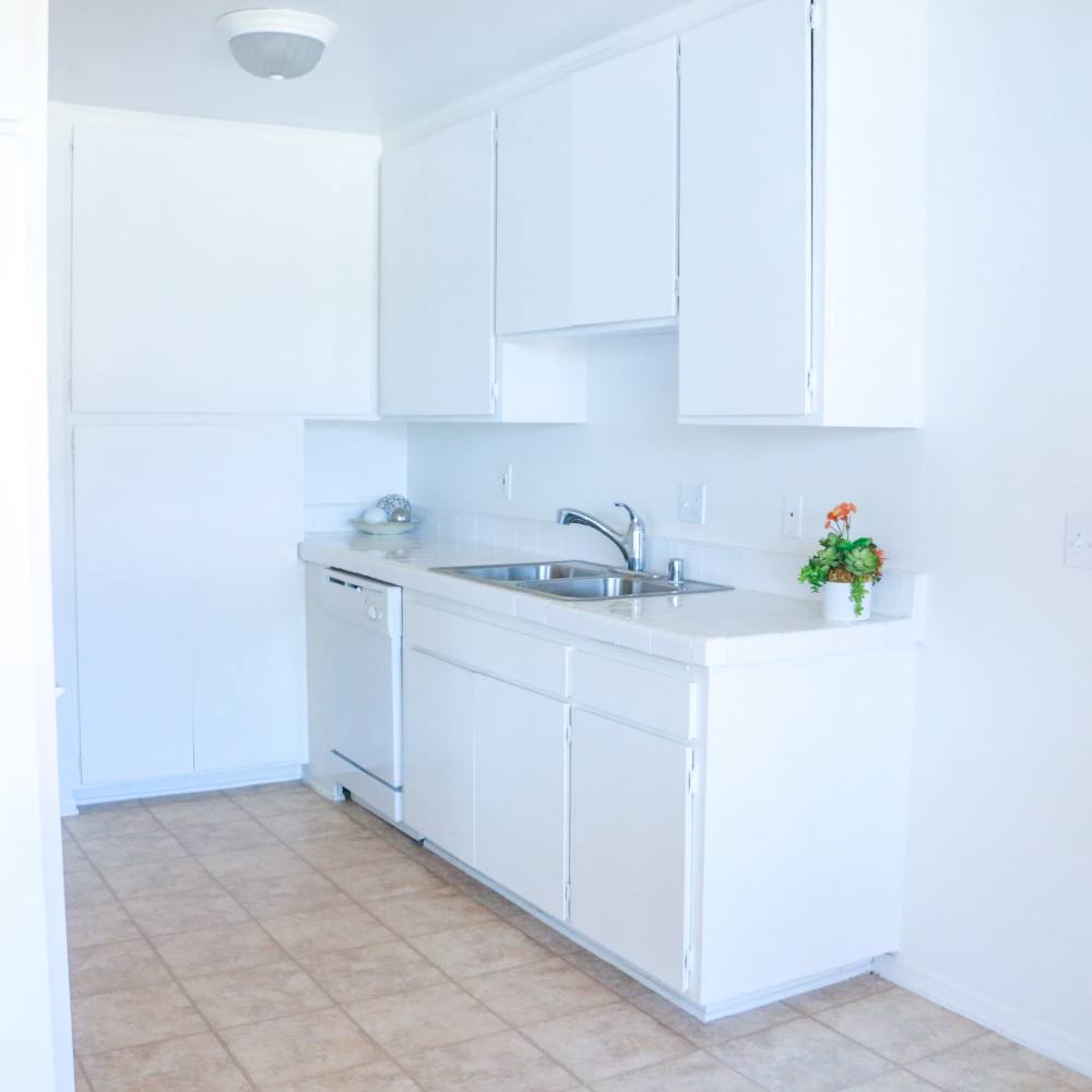Apartment kitchen with white appliances at Sandpointe in Huntington Beach, California