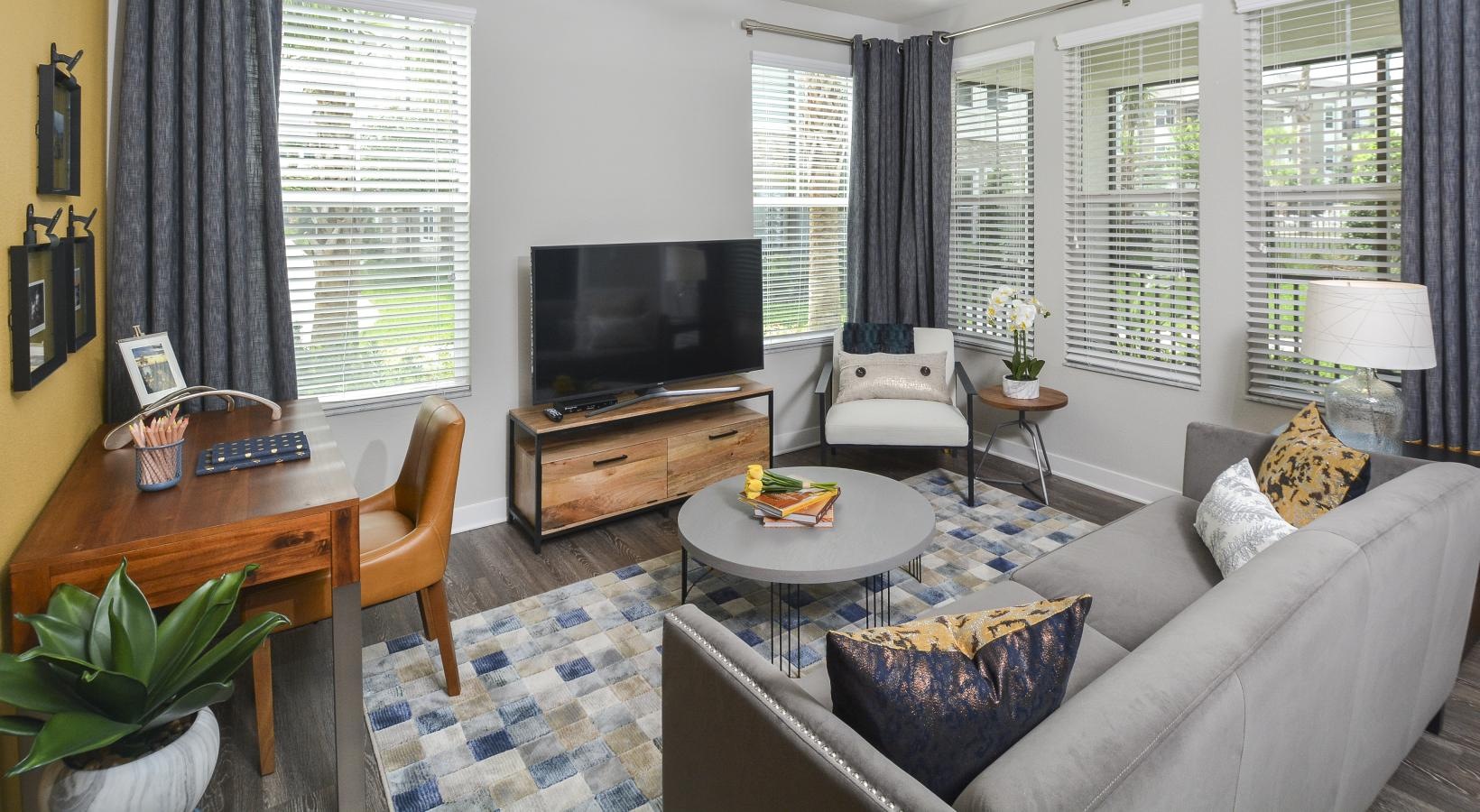 a living room with a tv and couches