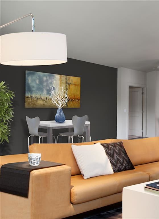 A modern living room with a sofa, coffee table, and kitchen area. at Kirkland Crossing Apartments, Kirkland, WA