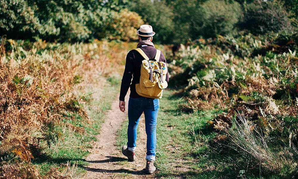 stylish man walking on trail