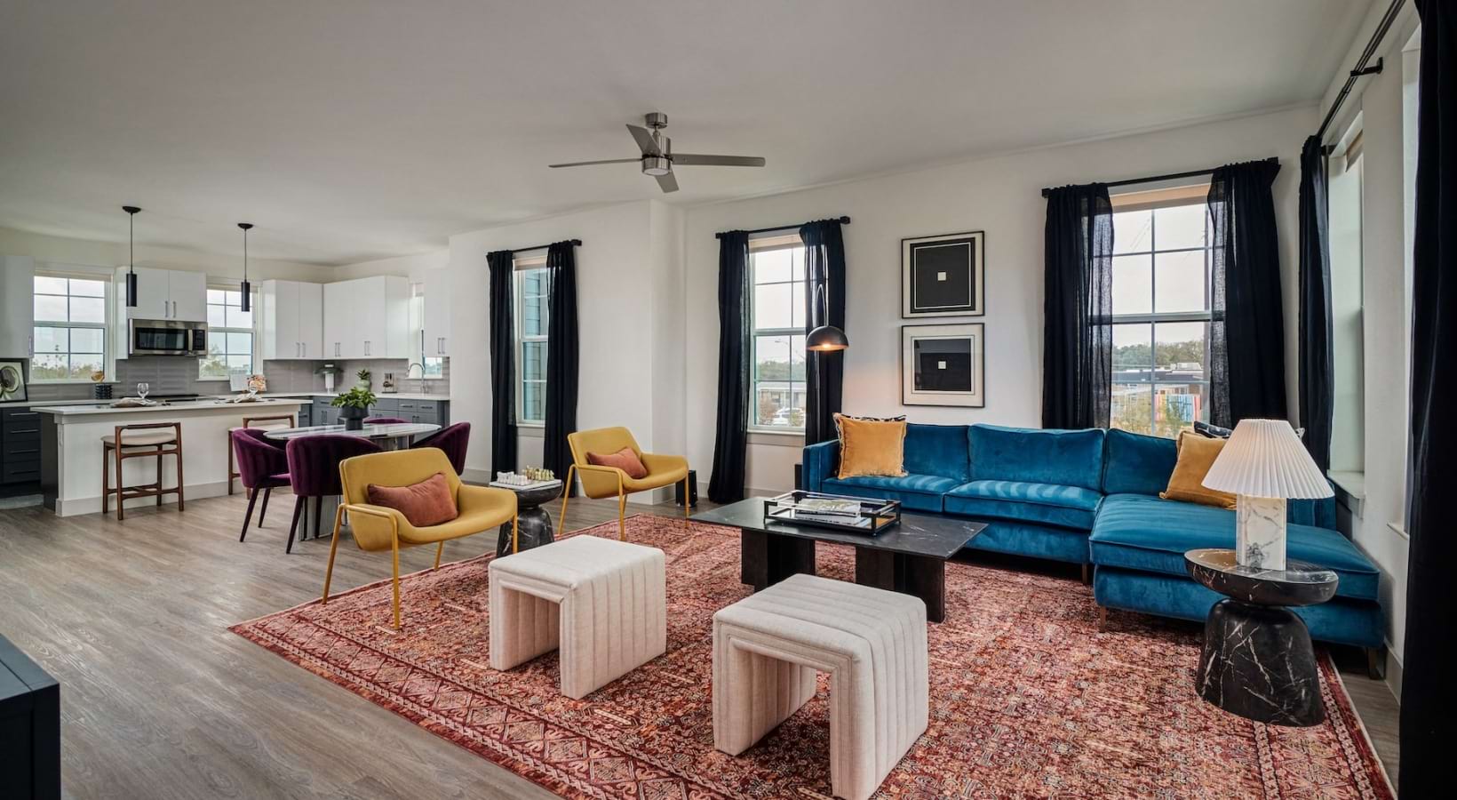 large living room connected to a well lit kitchen 