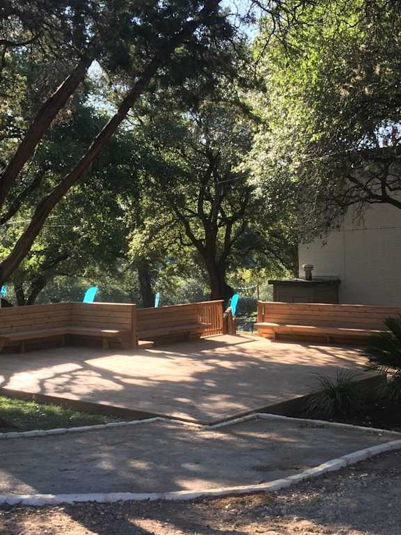 Outdoor deck with builtin seating and natural shade at Skyline at Barton Creek Apartments, Austin, Texas