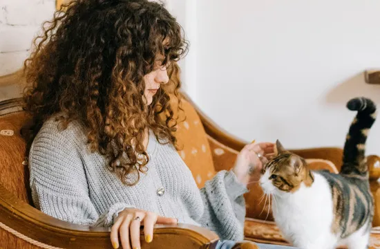 woman with cat on sofa