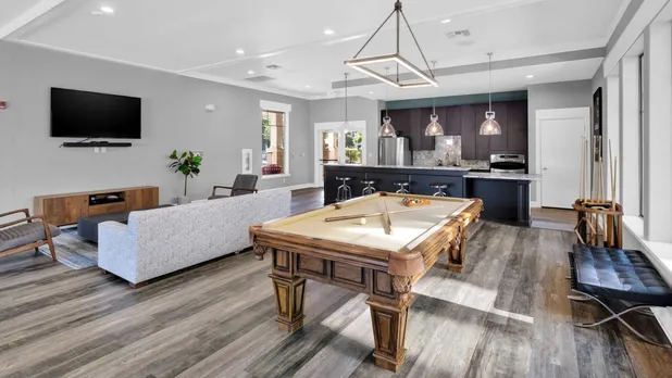 Indoor community center with pool table and couch and tv