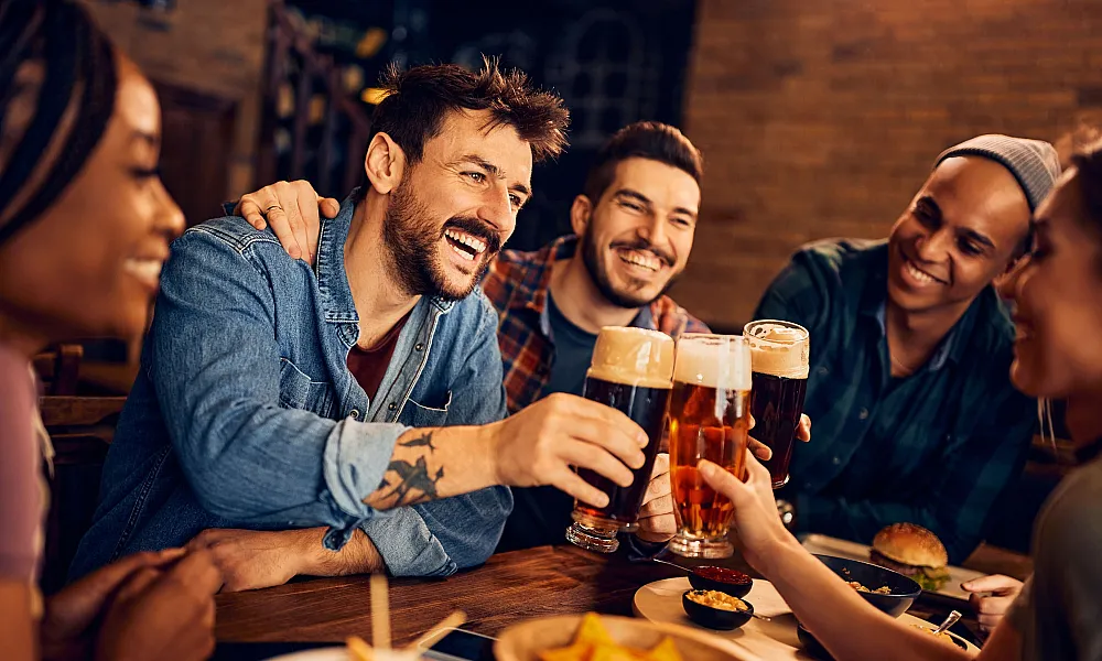 group of friends toasting a beer together