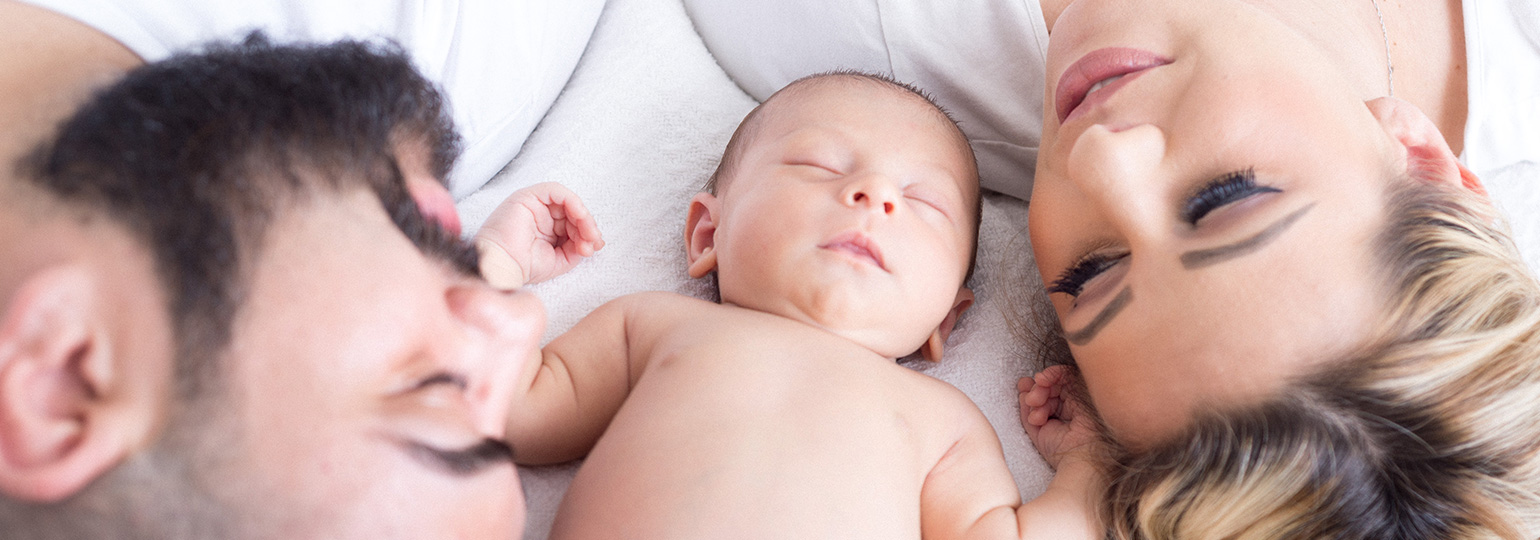 Baby sleeping with mom and dad
