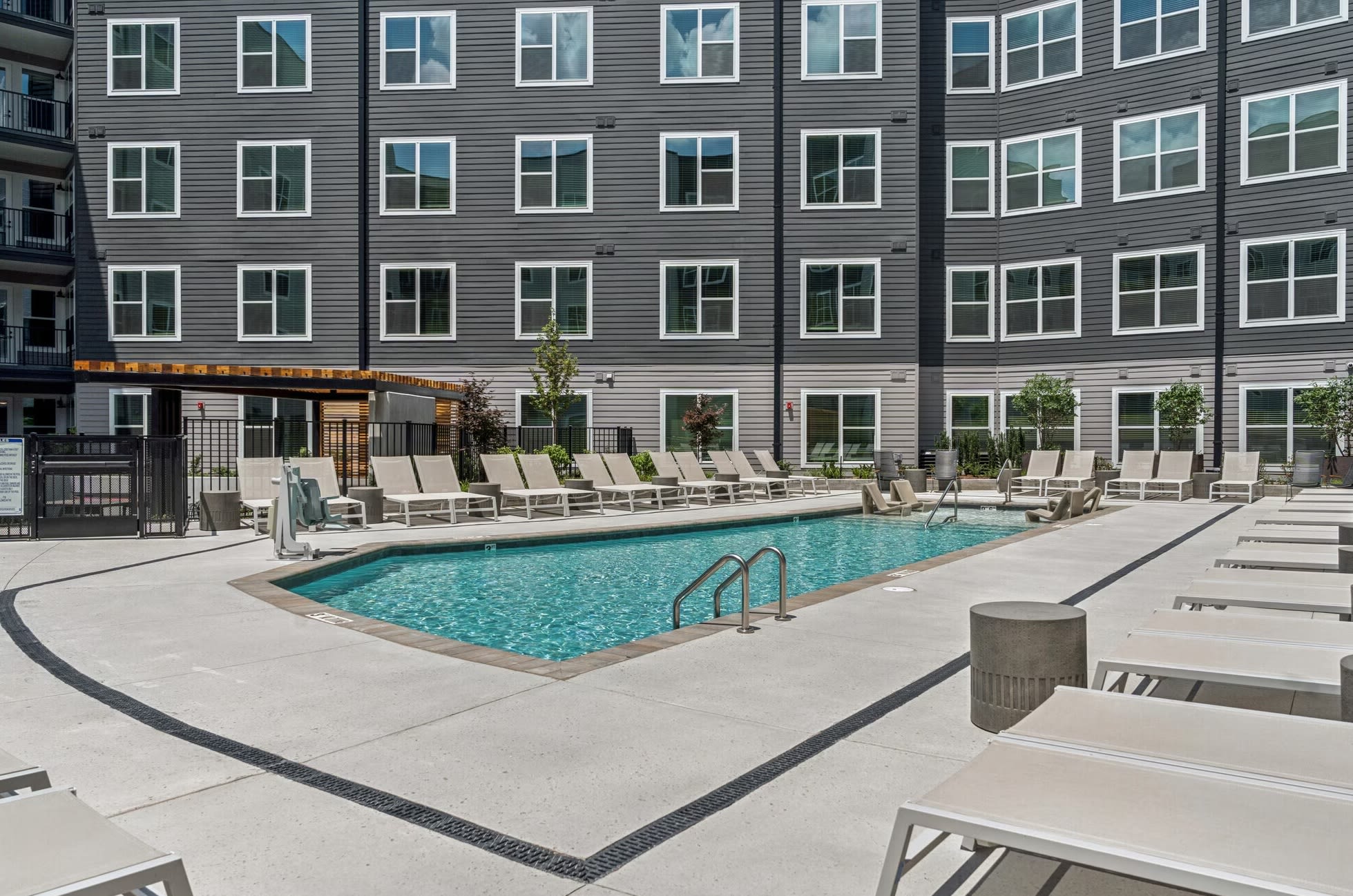 Resort-style pool with lounge seating at Oldham & Worth in Raleigh, NC