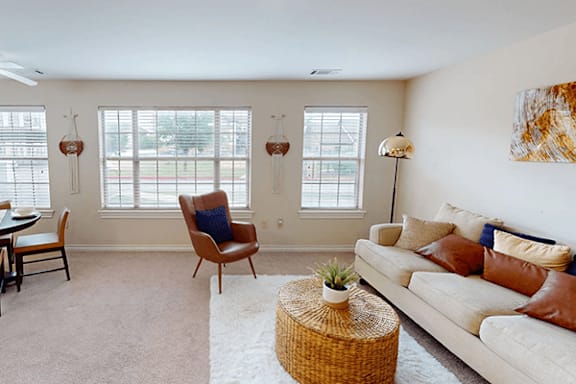 A living room with a couch, chair, and table.