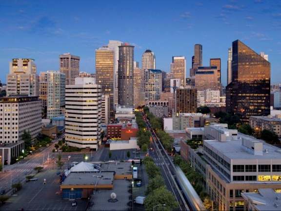 A cityscape with tall buildings and a clear sky at Skye Apartments, Seattle