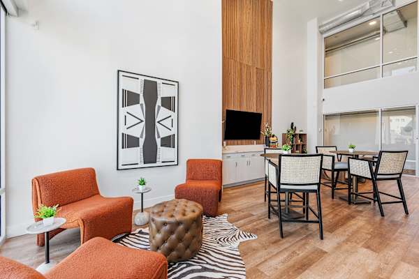A living room with orange chairs and a zebra rug. at The Revival, Salt Lake City