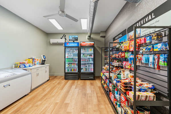 A room with a white wall and a black fridge. at The Revival, Salt Lake City, UT 84101