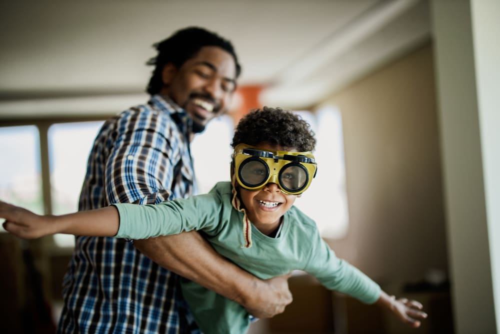 Resident father and son playing in their new home at a Morgan Properties community