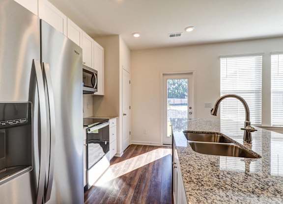 Townhomes Near The Citadel - Highland Townhomes - Kitchen With Stainless Steel Appliances, Granite Countertops, Plenty Of Storage, Pantry, And Kitchen Island