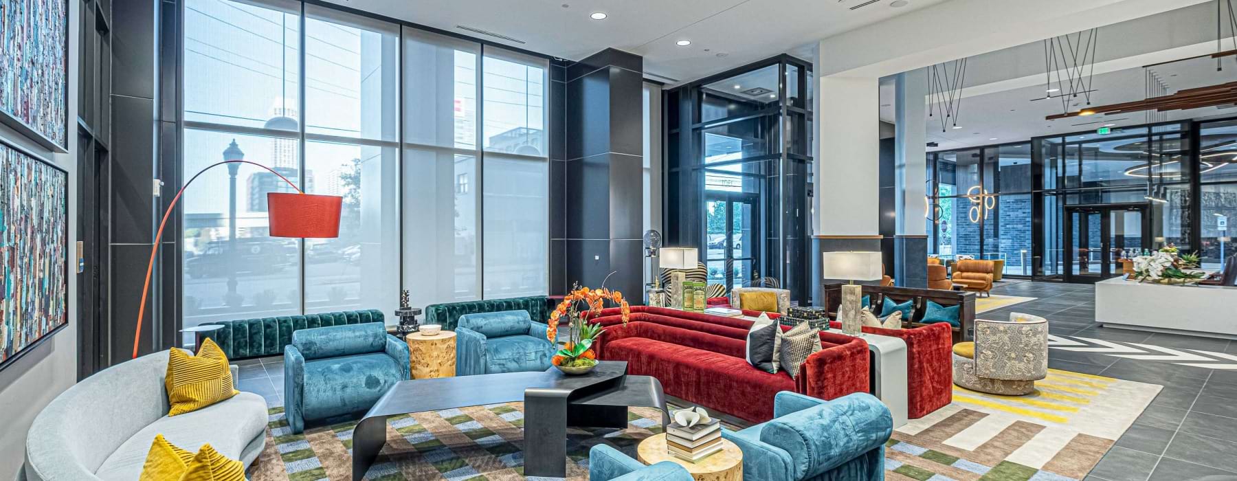 Furnished leasing office with large windows and lots of seating