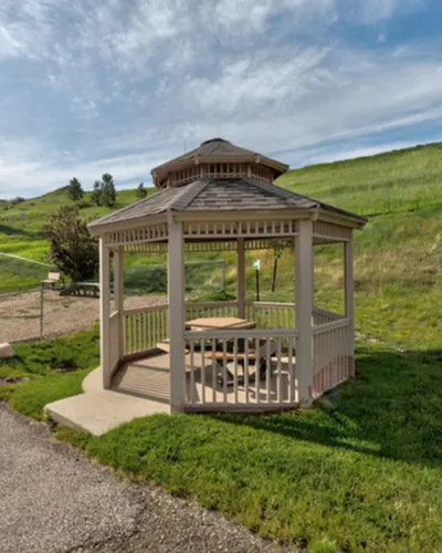 Charming outdoor gazebo set in scenic lush greenery, perfect for relaxation and outdoor gatherings.