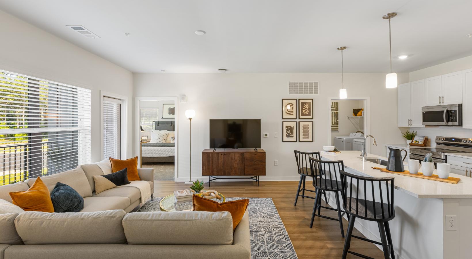 a living room with a large kitchen