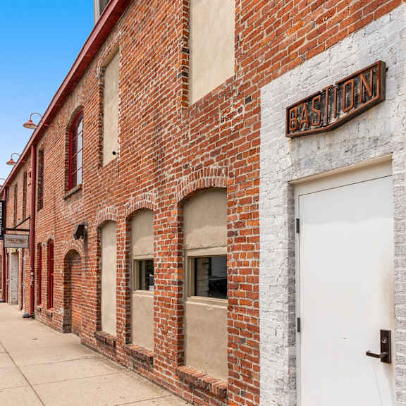 A long brick building with a sign that says Basement.