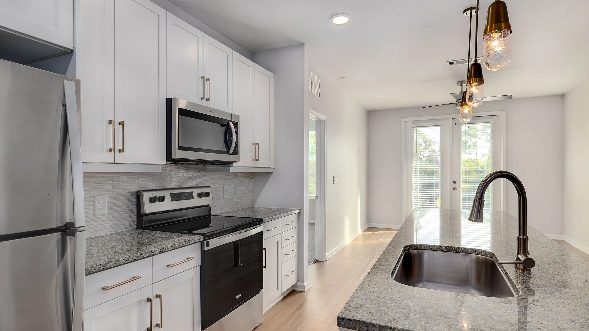 Modern kitchen with granite countertops and stainless steel appliances.