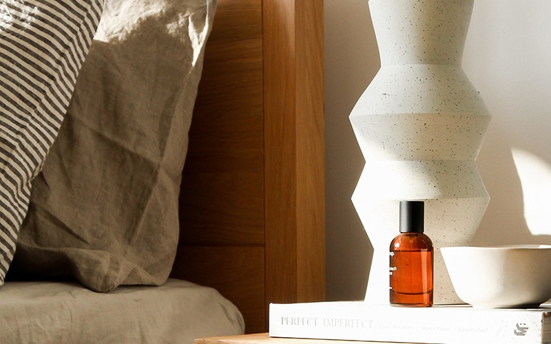 close-up of decor on a end-table beside a bed