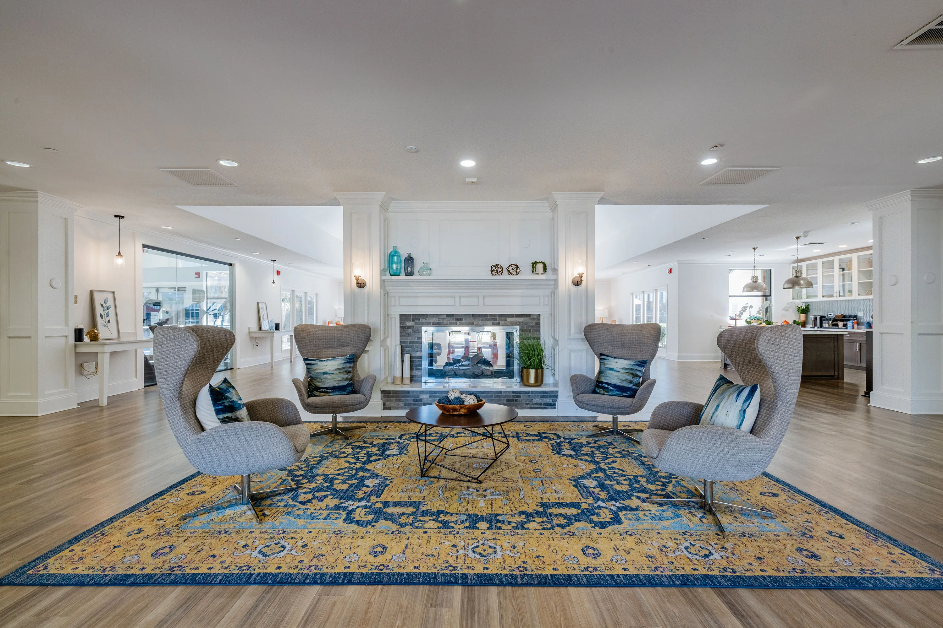 A family enjoys quality time together in a bright, cozy living room of an apartment, showcasing happiness and togetherness.
