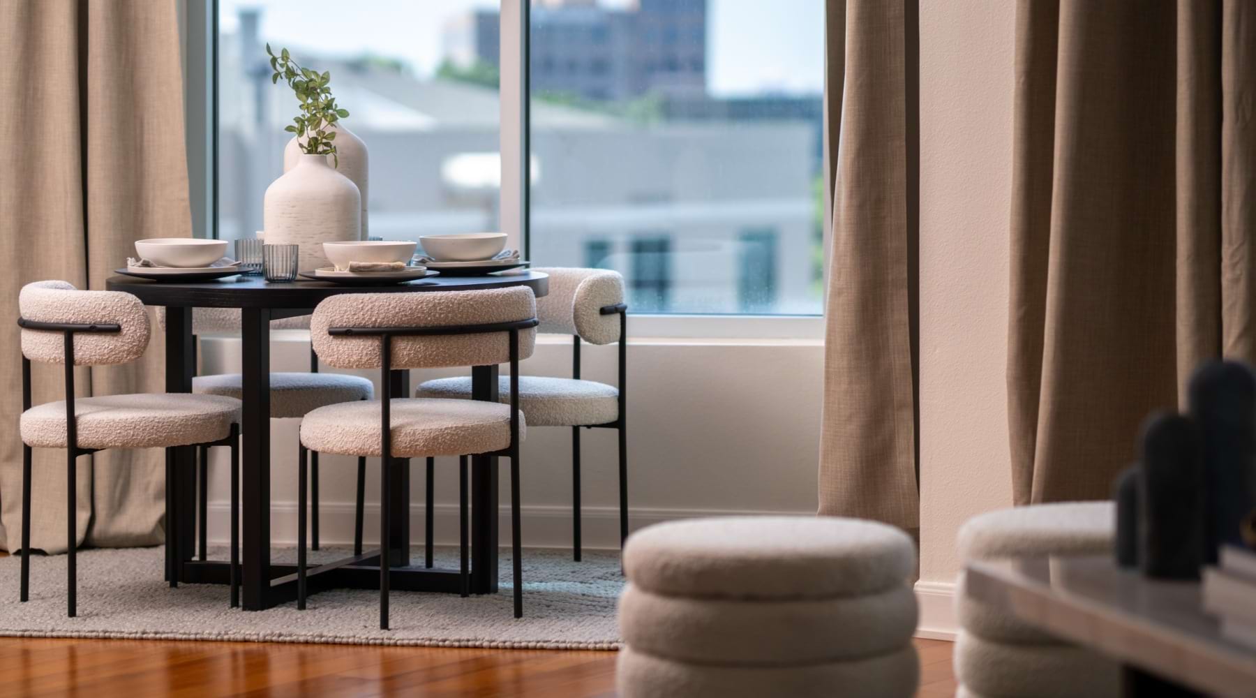a dining table near a large window