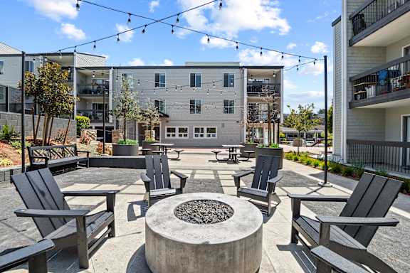 A patio with black chairs and a fire pit in front of a building at Delphine on Diamond, San Francisco, CA