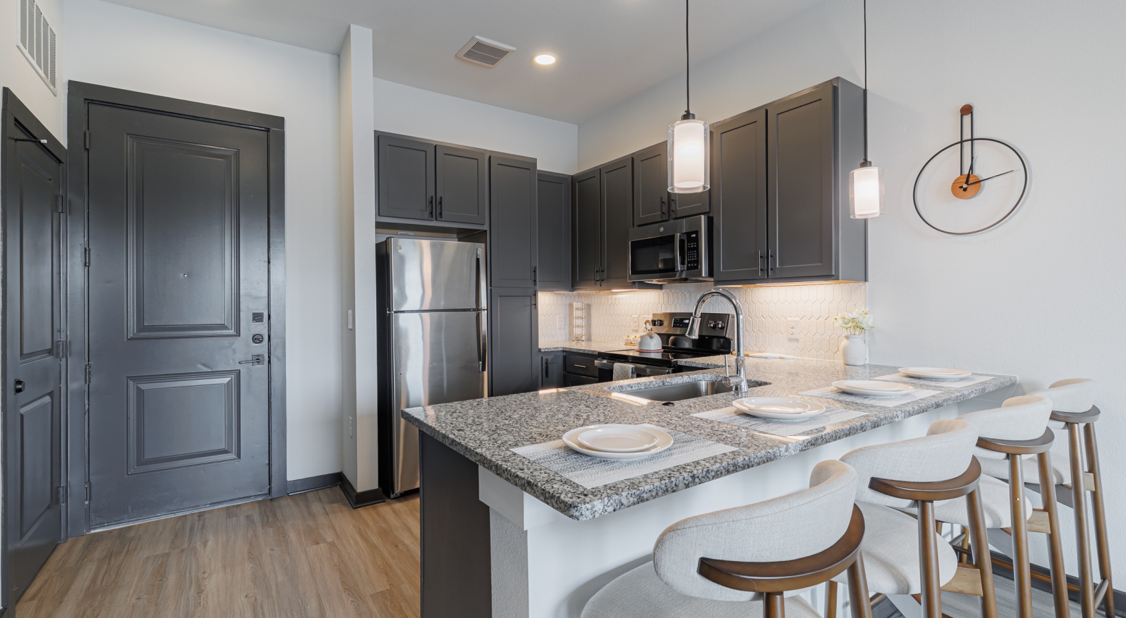 A2 1 Bed 1 Bath Kitchen: kitchen with barstools, large enough for 4 people, stainless steel appliances accessible from entryway